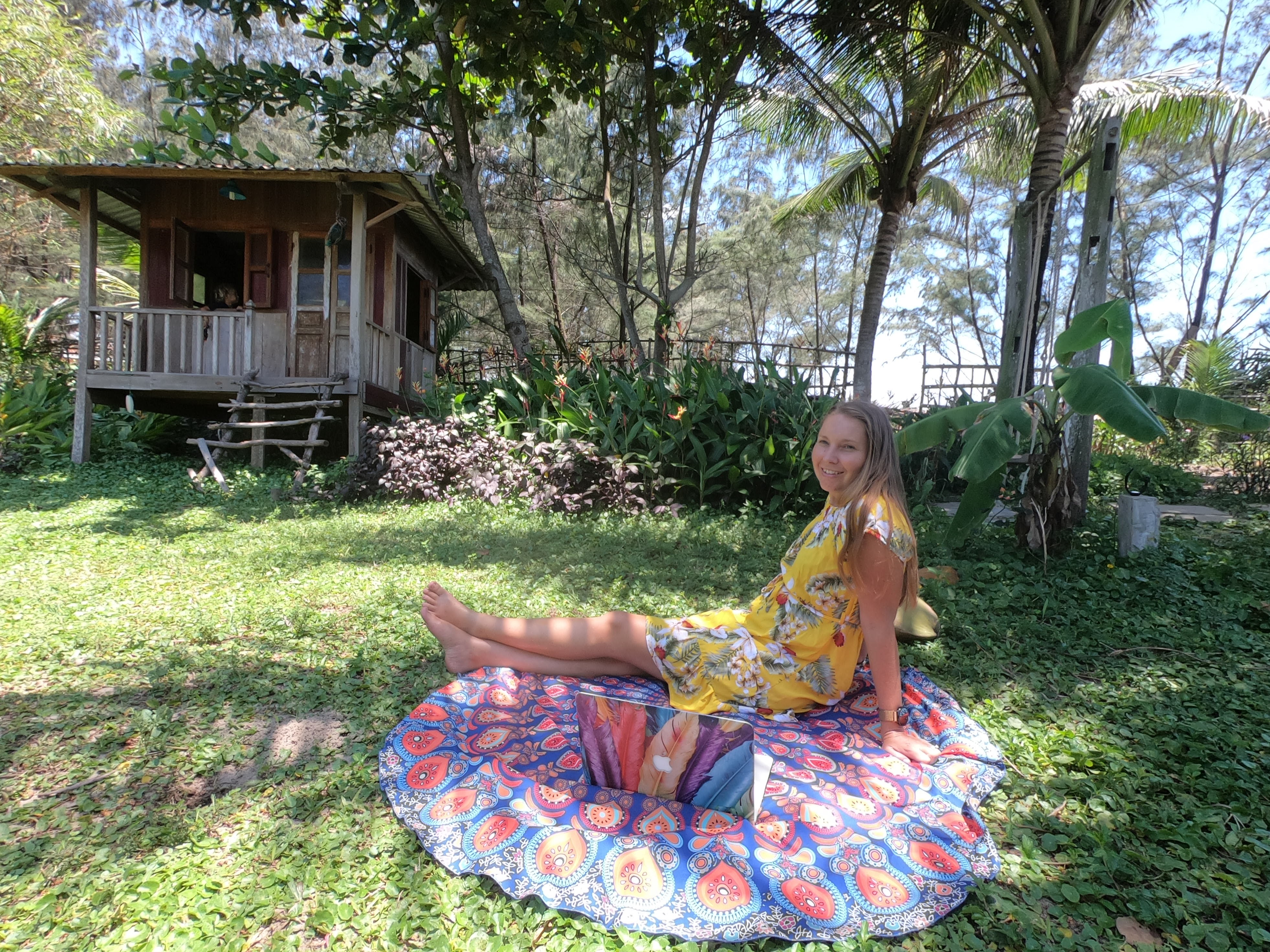 Woman working efficiently with AI tools on laptop in tropical setting, representing productivity breakthrough and work-life balance